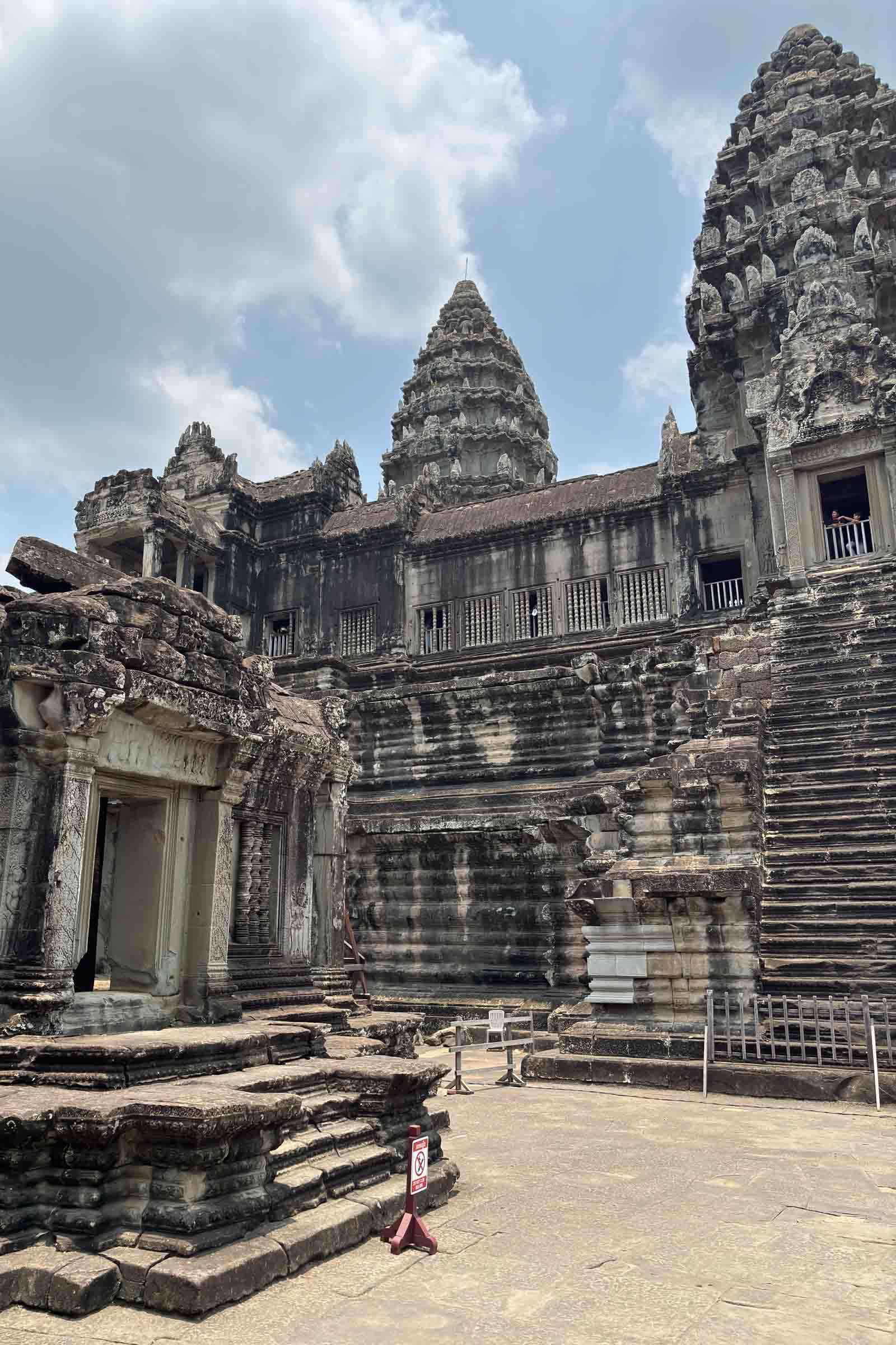 Step inside the legendary Angkor Wat and admire its timeless architecture. Massive stone pillars, adorned with intricate carvings, stand tall within the sacred halls of this Khmer masterpiece. Light and shadows dance along the temple’s corridors, revealing the grandeur of Cambodia’s most iconic monument
