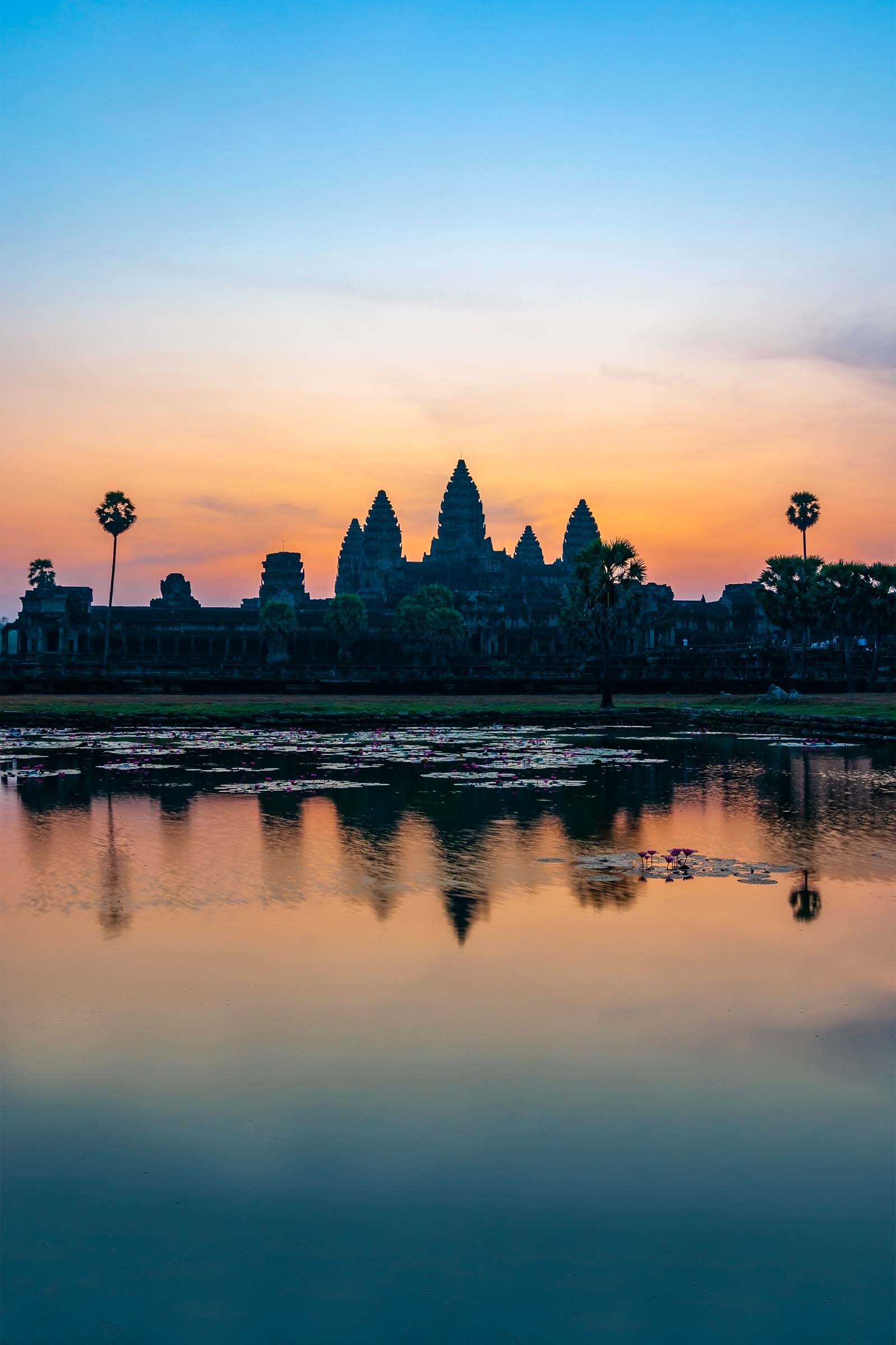 Vertical photograph of the Khmer archaeology complex of Angkor Wat at sunrise, Siem Reap, Cambodia.
