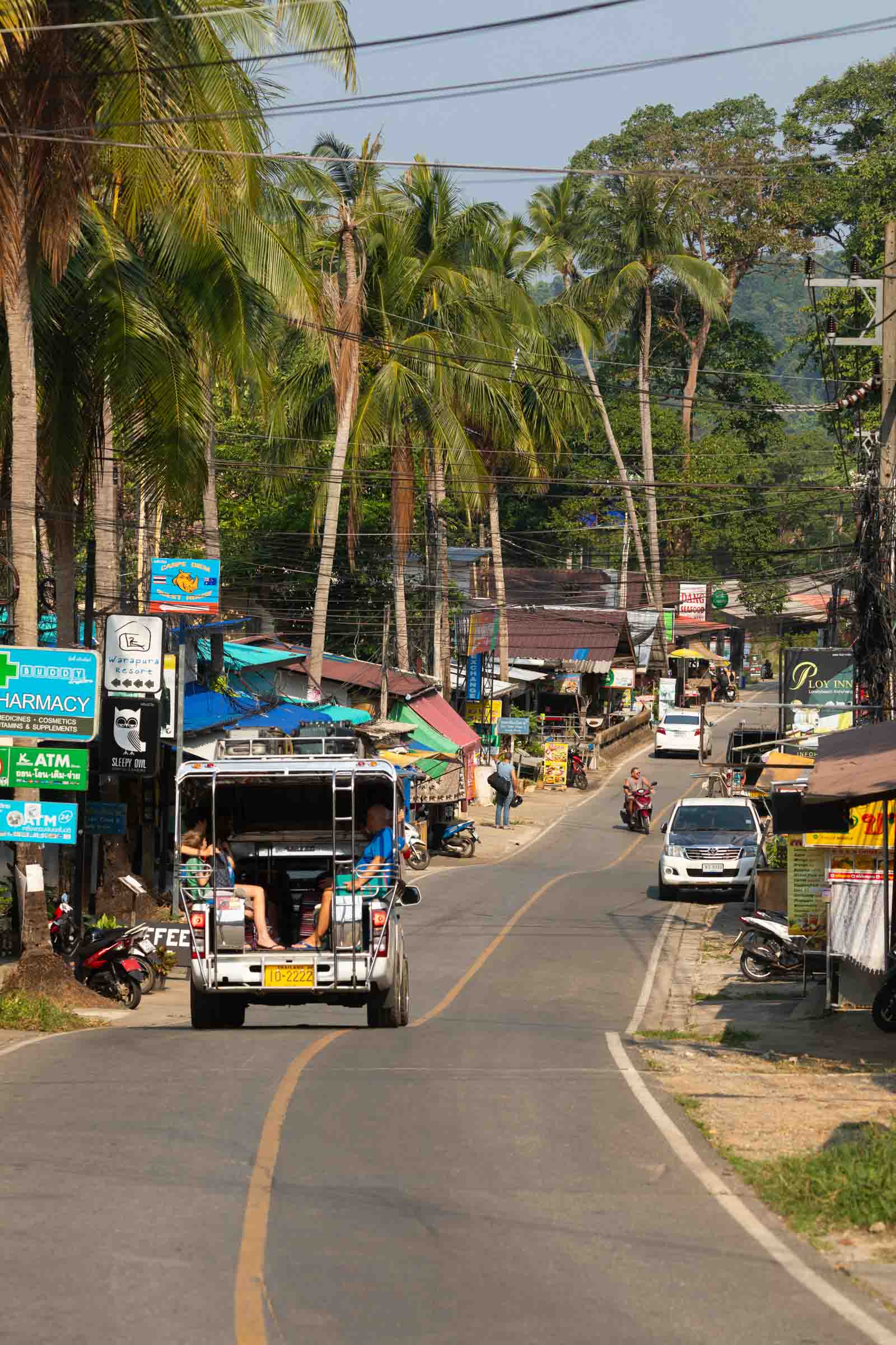 Thailand - Jan 15, 2020: Road and vehicles in an inhabited area of the west of the island of Koh Chang, in the Gulf of Thailand, near Lonely Beach