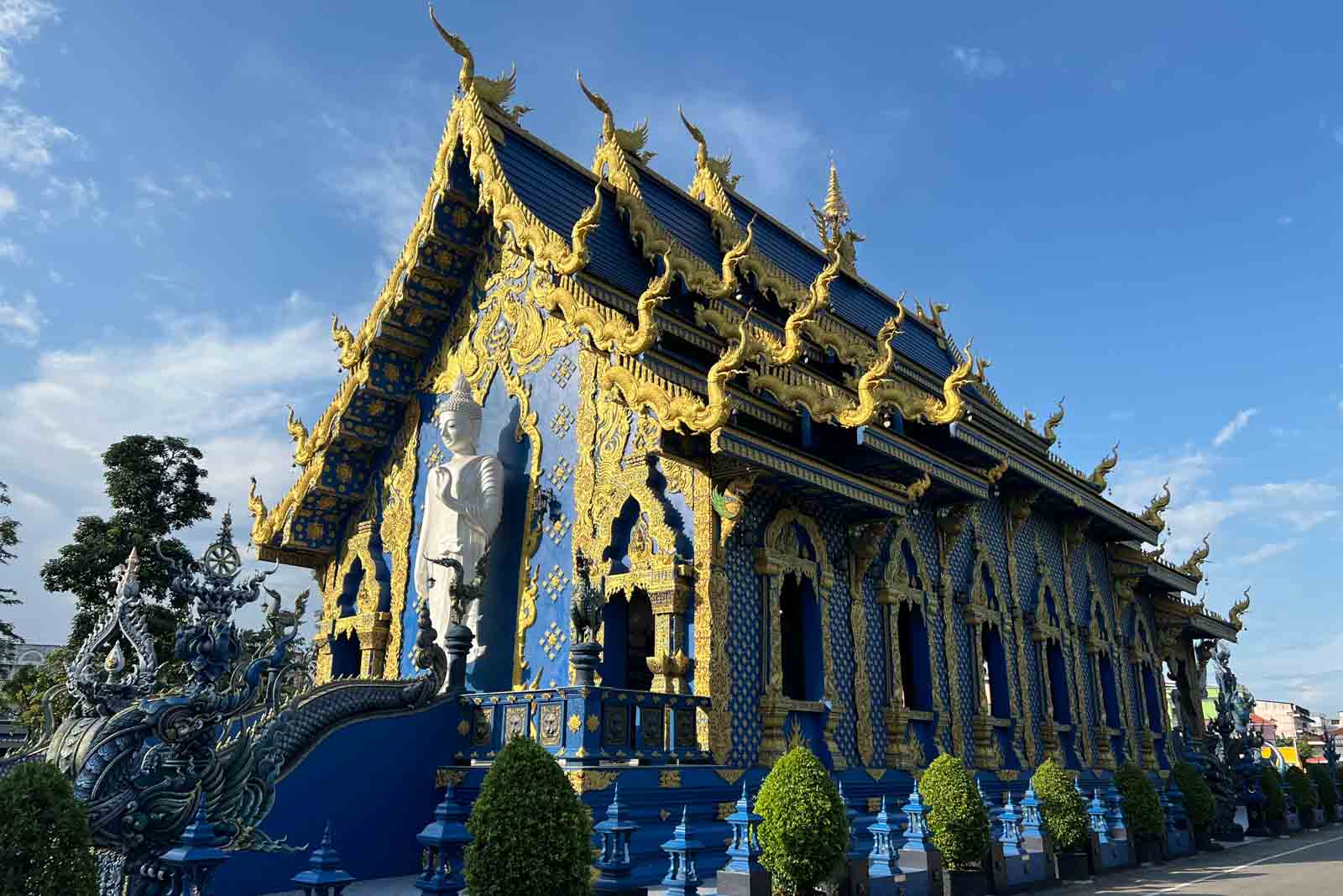 Stunning view of the Blue Temple in Chiang Rai Thailand featuring intricate designs and statues.
