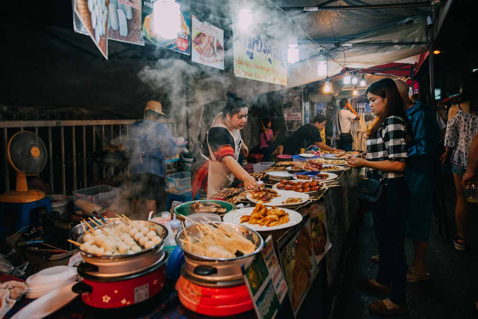 Chiang Mai, Thailand - August 27, 2016: Thai woman sales at the Saturday Night Market on August 27, 2016 in Chiang Mai, Thailand.